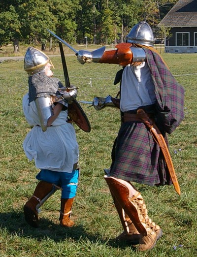 Squire Kale ducks under Angus Fraser's head blow.