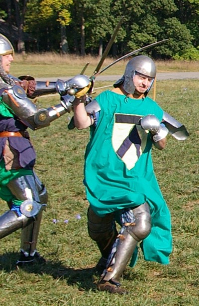 Squire Riochard grimaces from the impact of Squire Matthew's blow.