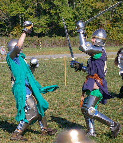 Squire Matthew advances on the retreating Squire Riochard.